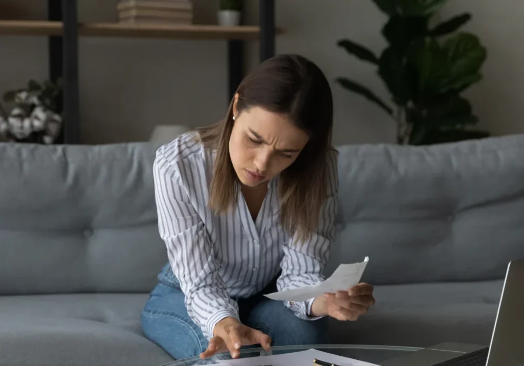 Woman reviewing financial documents indoors